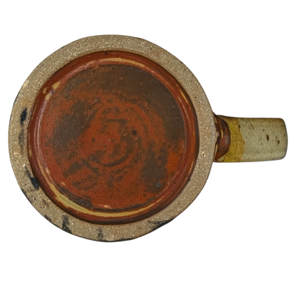 Bottom view of vintage Caffe Pergolesi mug showing rustic ceramic base and handle