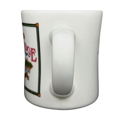 Side view of a vintage G.H. Bass mountain ridge mug with colorful design and sturdy handle