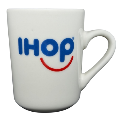 Vintage IHOP smiley mug in white with blue IHOP logo and smiling face design