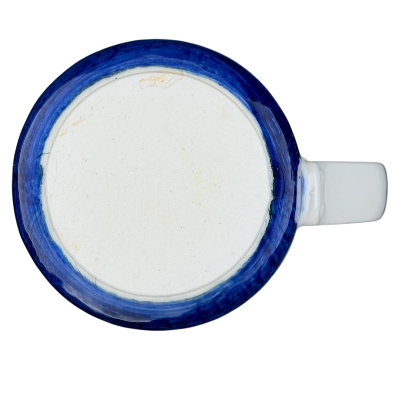 Top view of a vintage Otagiri sailboat mug with a blue rim and white base
