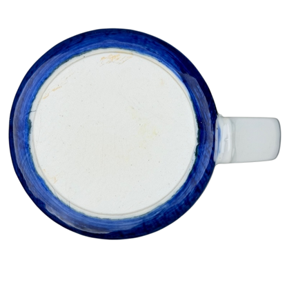Top view of a vintage Otagiri sailboat mug with a blue rim and white base