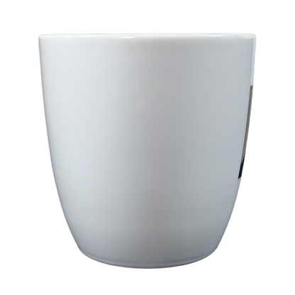 White coffee mug shown from the back with a vintage Peet's Coffee mug gold frame design on the front