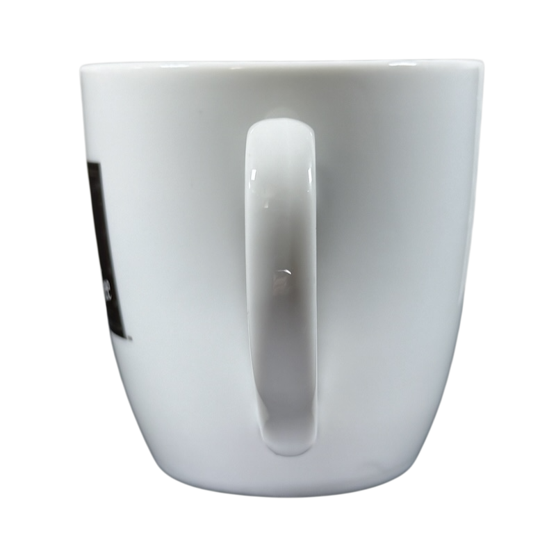 Side view of vintage Peet's Coffee mug gold frame with white ceramic and handle