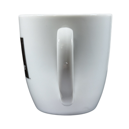 Side view of vintage Peet's Coffee mug gold frame with white ceramic and handle