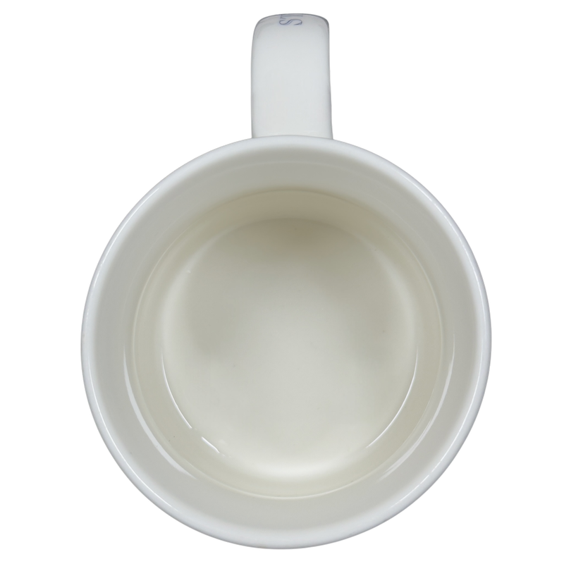Interior view of a vintage Pike Place Starbucks mug showing a smooth white ceramic finish