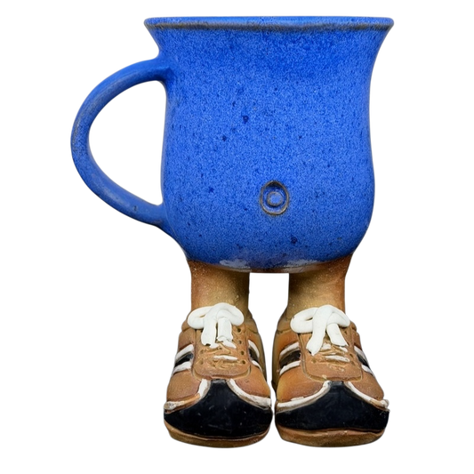 Whimsical blue vintage running shoes coffee mug featuring sneaker-shaped feet