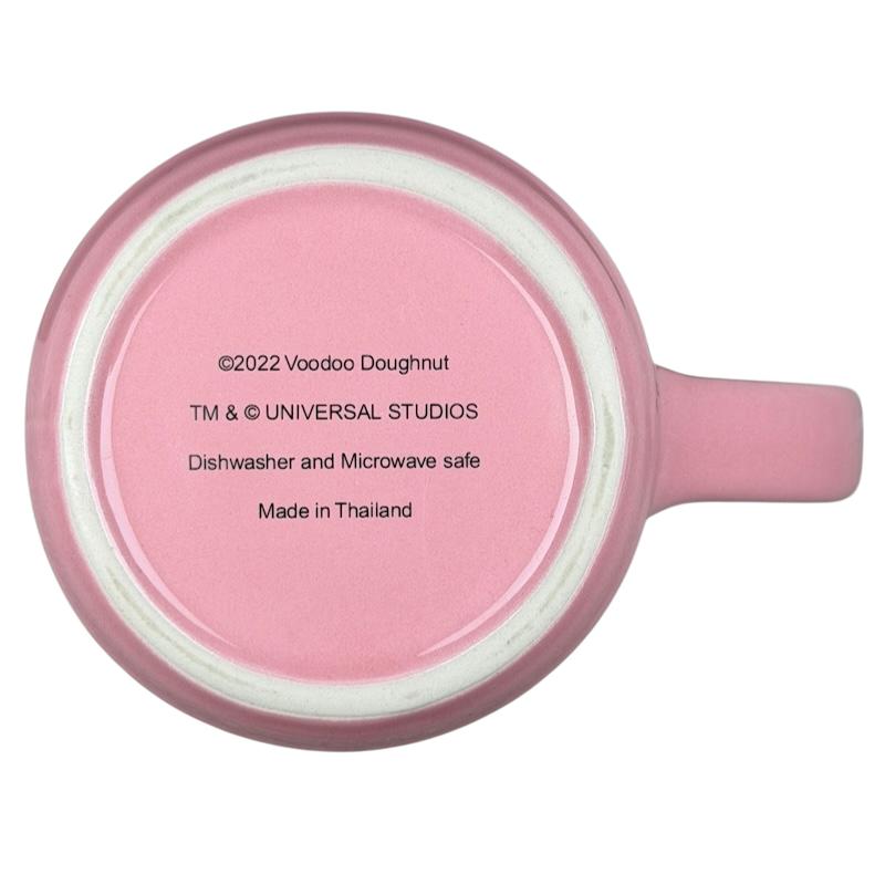 Bottom view of Voodoo Doughnut Universal Orlando mug showing care instructions and branding