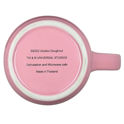 Bottom view of Voodoo Doughnut Universal Orlando mug showing care instructions and branding