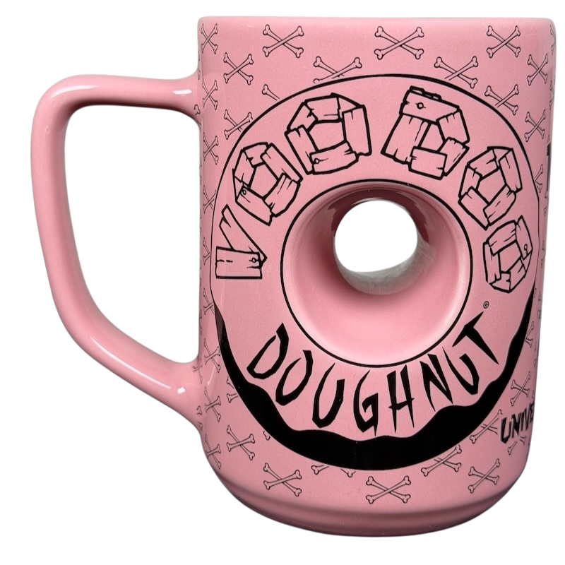 Voodoo Doughnut Universal Orlando mug in pink with donut design and skull pattern