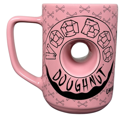 Voodoo Doughnut Universal Orlando mug in pink with donut design and skull pattern