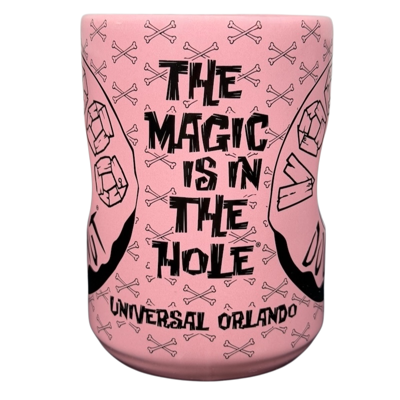 Voodoo Doughnut Universal Orlando mug with pink design and bold text featuring skulls and crossed bones