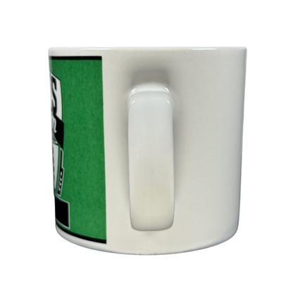 Side view of white ceramic mug with handle and green logo Kasper's Yester Year vintage coffee mug Westwood