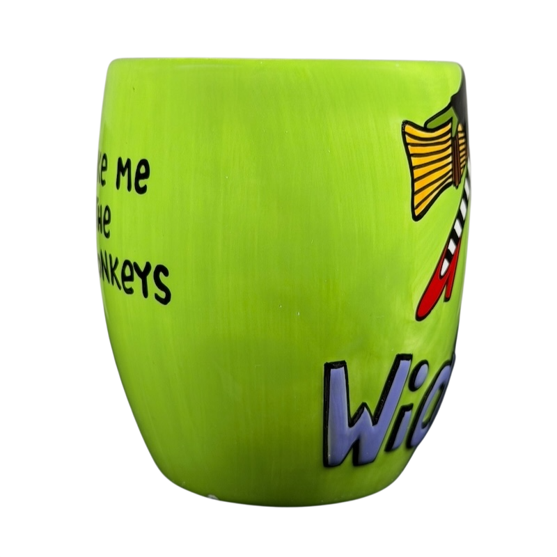 Wicked Wizard of Oz flying monkeys mug in vibrant green with playful design and text