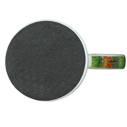 Top view of Woman in the Garden Claude Monet Mug Chaleur with a handle and vibrant garden design