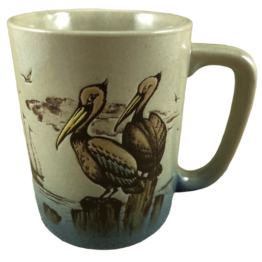 Pelicans Sitting On Tree Trunks And A Sailboat In The Ocean Embossed Mug Otagiri