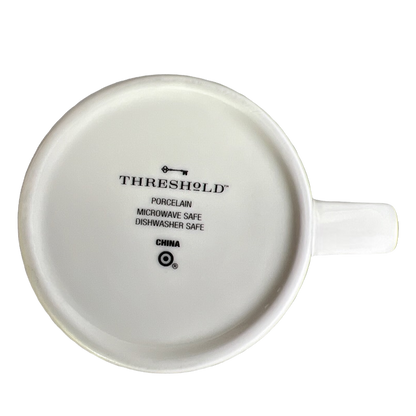 Bottom view of white Threshold Pisces astrology mug showing Threshold logo and microwave dishwasher safe marks